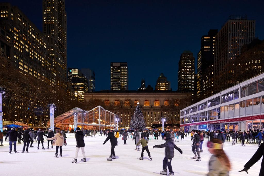 Friends and families enjoy Bryant Park's Winter Village ice skating rink.