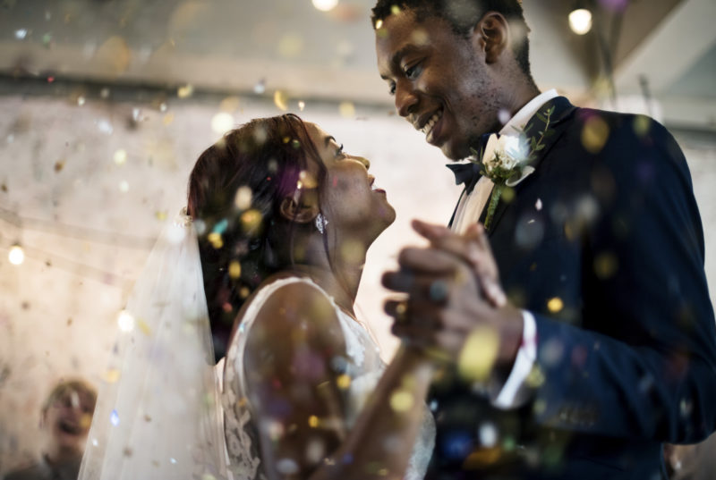 Newlywed african descent couple dancing wedding celebration