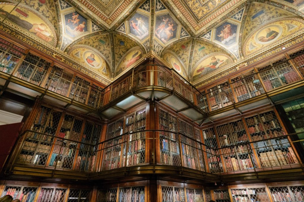 Two stories of books and intricate ceilings at the Morgan Library & Museum in NYC.
