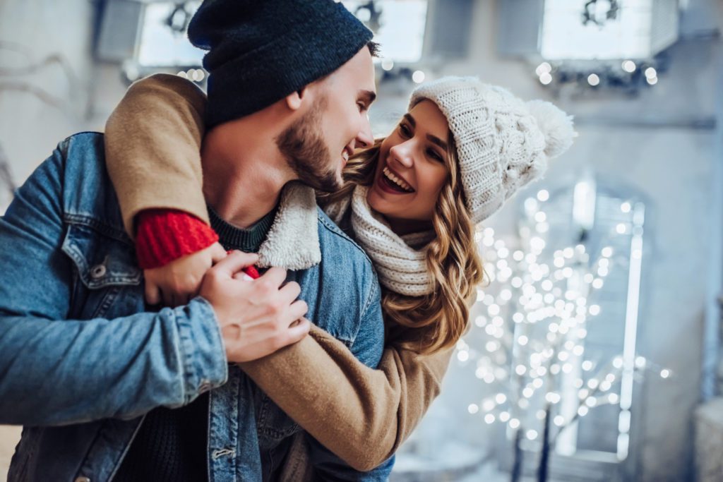 Young romantic couple is having fun outdoors in winter