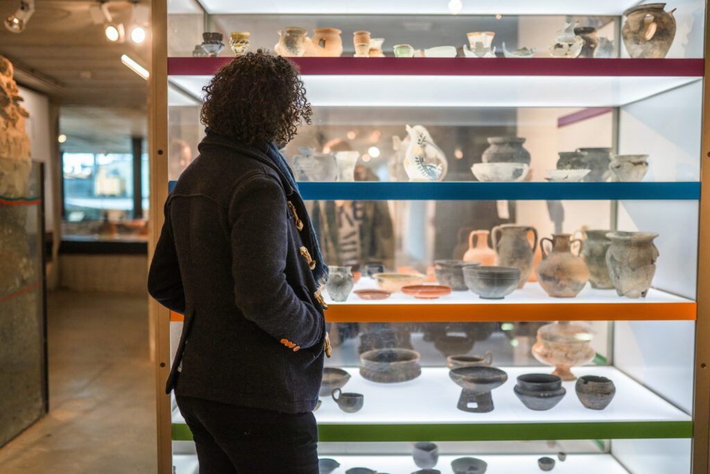 Visitor and Ancient Pottery at NYC museum