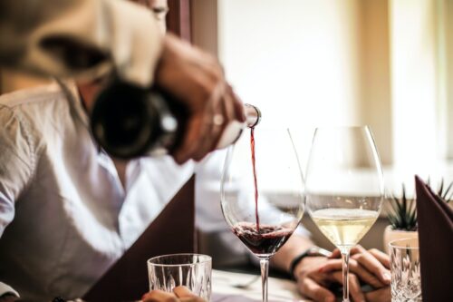 Server pouring a glass of wine at an NYC winery.